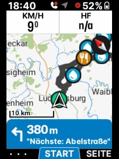 Photo of an ELEMNT screen: a route with water and food stop markers strung along it, and the next turn — 380 m, Abelstraße — announced at the bottom.